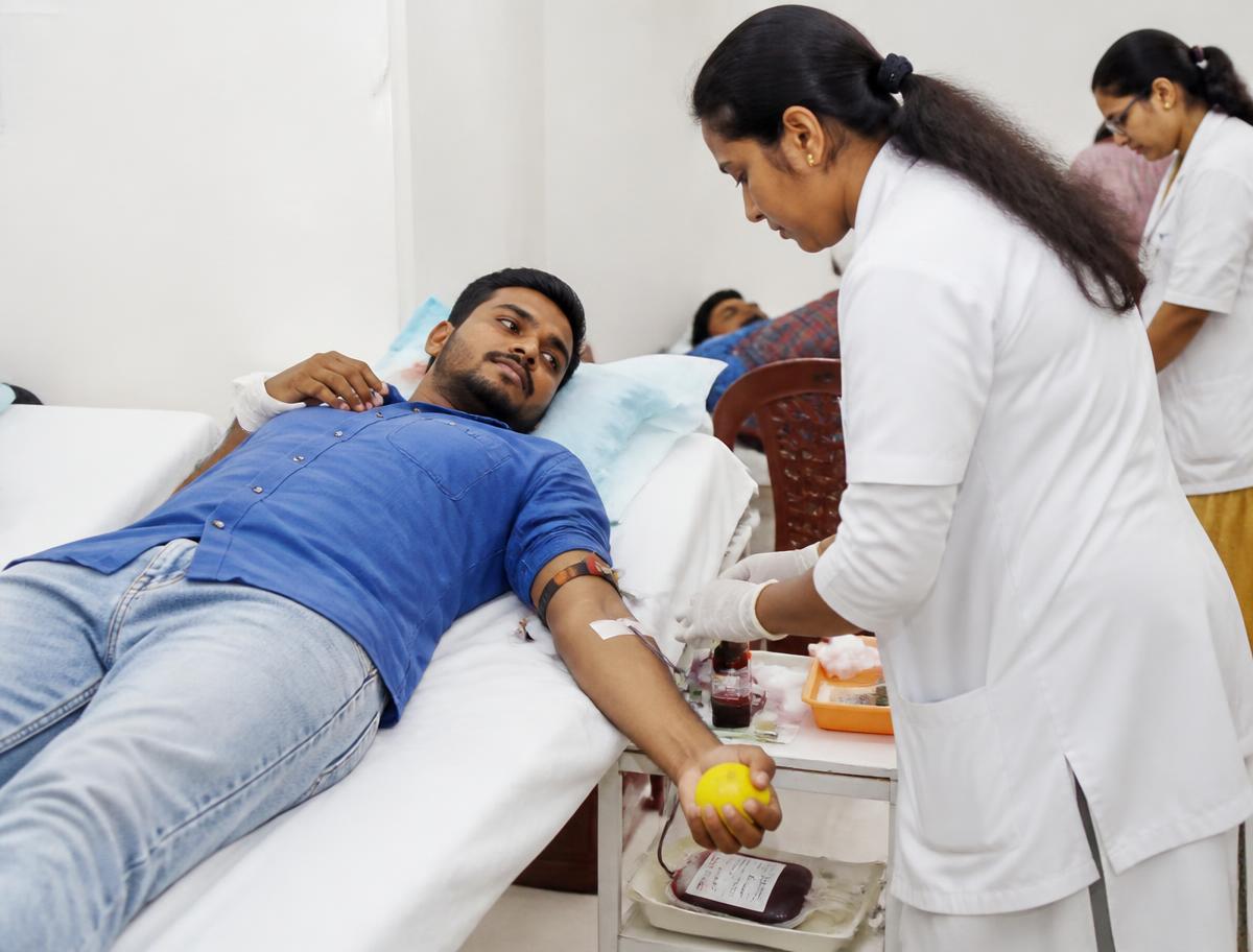 Blood donation camp with a nurse attending a donor
